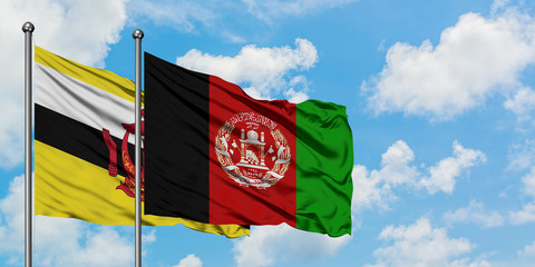 Brunei and Afghanistan flag waving in the wind against white cloudy blue sky together. Diplomacy concept, international relations.