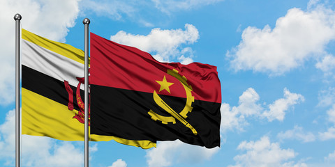 Brunei and Angola flag waving in the wind against white cloudy blue sky together. Diplomacy concept, international relations.