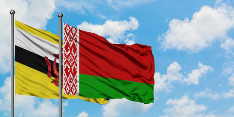 Brunei and Belarus flag waving in the wind against white cloudy blue sky together. Diplomacy concept, international relations.