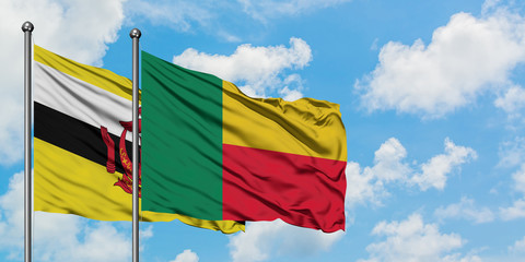 Brunei and Benin flag waving in the wind against white cloudy blue sky together. Diplomacy concept, international relations.
