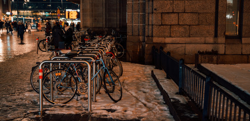 Fototapeta na wymiar Bicycle parking outdoors on winter evening