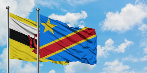 Brunei and Congo flag waving in the wind against white cloudy blue sky together. Diplomacy concept, international relations.
