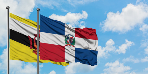 Brunei and Dominican Republic flag waving in the wind against white cloudy blue sky together. Diplomacy concept, international relations.