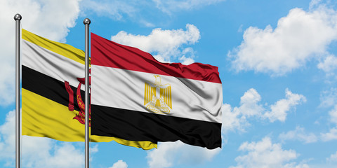 Brunei and Egypt flag waving in the wind against white cloudy blue sky together. Diplomacy concept, international relations.