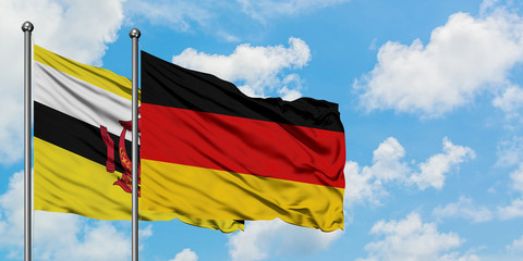 Brunei and Germany flag waving in the wind against white cloudy blue sky together. Diplomacy concept, international relations.