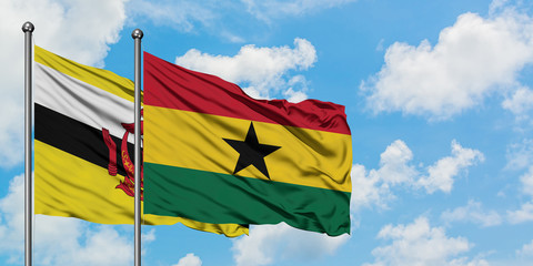 Brunei and Ghana flag waving in the wind against white cloudy blue sky together. Diplomacy concept, international relations.