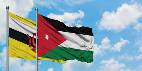 Brunei and Jordan flag waving in the wind against white cloudy blue sky together. Diplomacy concept, international relations.