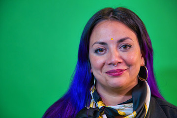 portrait of latin woman blue and purple painted hair with background view