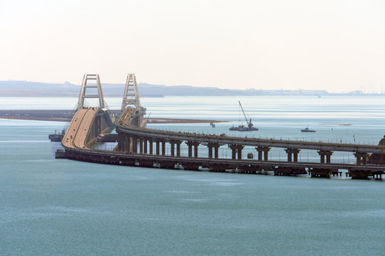 Crimean Bridge across Kerch Strait between Black and Azov Seas connecting Kuban and Crimea. Close telephoto view from Mithridates observation deck in Kerch on sunny day. Crimean Peninsula, Russia.