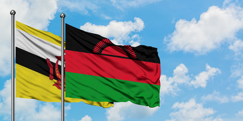 Brunei and Malawi flag waving in the wind against white cloudy blue sky together. Diplomacy concept, international relations.