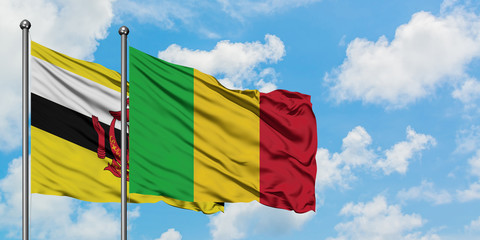 Brunei and Mali flag waving in the wind against white cloudy blue sky together. Diplomacy concept, international relations.