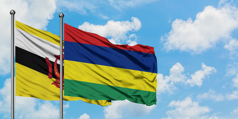 Brunei and Mauritius flag waving in the wind against white cloudy blue sky together. Diplomacy concept, international relations.