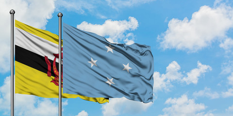 Brunei and Micronesia flag waving in the wind against white cloudy blue sky together. Diplomacy concept, international relations.