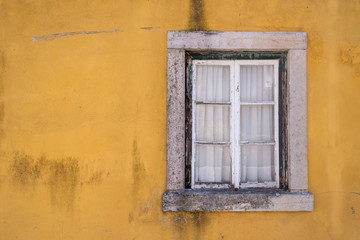 Fototapeta na wymiar white window ce old wood with yellow wall