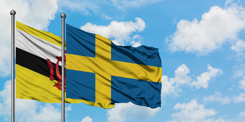 Brunei and Sweden flag waving in the wind against white cloudy blue sky together. Diplomacy concept, international relations.