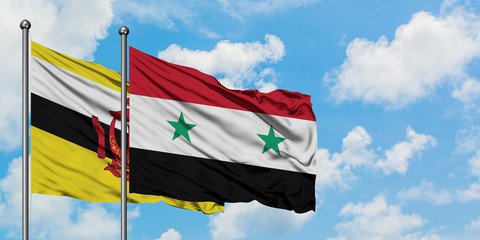 Brunei and Syria flag waving in the wind against white cloudy blue sky together. Diplomacy concept, international relations.