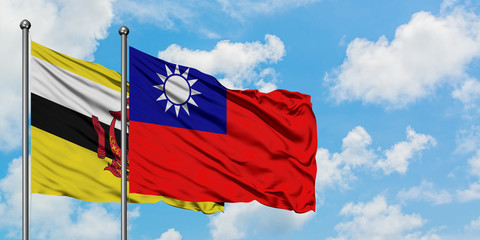 Brunei and Taiwan flag waving in the wind against white cloudy blue sky together. Diplomacy concept, international relations.