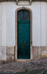 Fototapeta na wymiar Old dark green thin wooden door