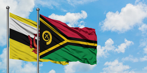 Brunei and Vanuatu flag waving in the wind against white cloudy blue sky together. Diplomacy concept, international relations.