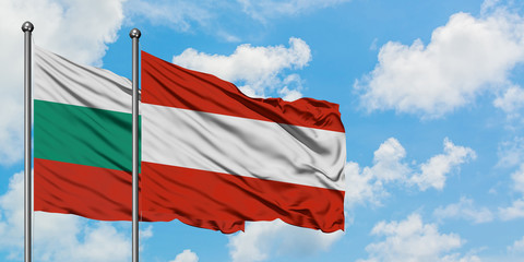 Bulgaria and Austria flag waving in the wind against white cloudy blue sky together. Diplomacy concept, international relations.