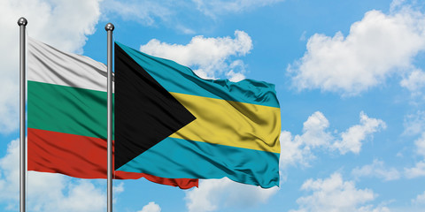 Bulgaria and Bahamas flag waving in the wind against white cloudy blue sky together. Diplomacy concept, international relations.