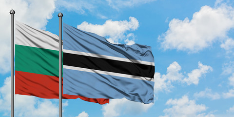Bulgaria and Botswana flag waving in the wind against white cloudy blue sky together. Diplomacy concept, international relations.