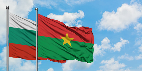 Bulgaria and Burkina Faso flag waving in the wind against white cloudy blue sky together. Diplomacy concept, international relations.
