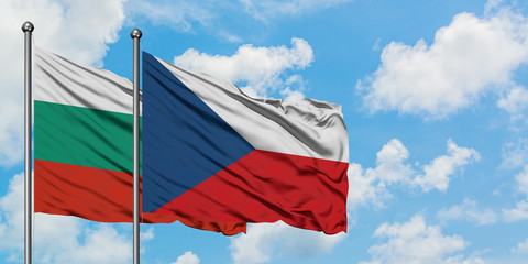 Bulgaria and Czech Republic flag waving in the wind against white cloudy blue sky together. Diplomacy concept, international relations.