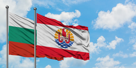 Bulgaria and French Polynesia flag waving in the wind against white cloudy blue sky together. Diplomacy concept, international relations.