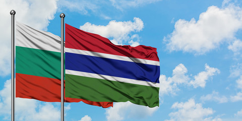 Bulgaria and Gambia flag waving in the wind against white cloudy blue sky together. Diplomacy concept, international relations.