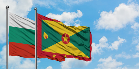 Bulgaria and Grenada flag waving in the wind against white cloudy blue sky together. Diplomacy concept, international relations.