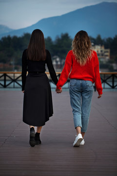 lesbian couple holding hands, girl friends, romantic moment