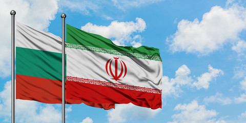 Bulgaria and Iran flag waving in the wind against white cloudy blue sky together. Diplomacy concept, international relations.