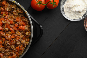 Cooking Italian lasagna, frying in a skillet dressing. Background for design. Cooking process. Top view.