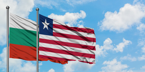 Bulgaria and Liberia flag waving in the wind against white cloudy blue sky together. Diplomacy concept, international relations.