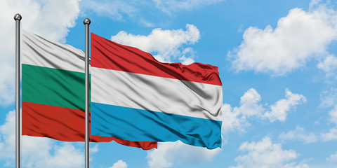 Bulgaria and Luxembourg flag waving in the wind against white cloudy blue sky together. Diplomacy concept, international relations.