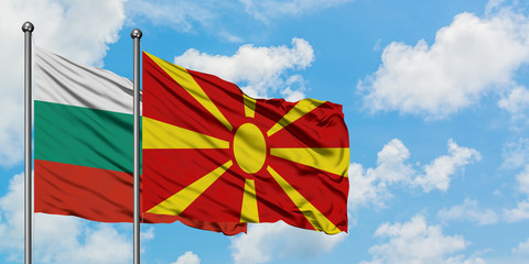 Bulgaria and Macedonia flag waving in the wind against white cloudy blue sky together. Diplomacy concept, international relations.