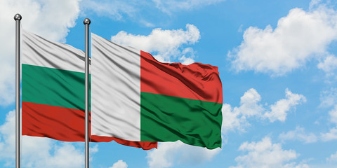 Bulgaria and Madagascar flag waving in the wind against white cloudy blue sky together. Diplomacy concept, international relations.