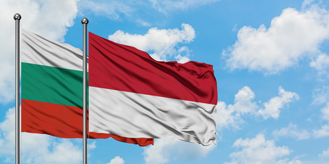 Bulgaria and Monaco flag waving in the wind against white cloudy blue sky together. Diplomacy concept, international relations.