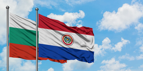 Bulgaria and Paraguay flag waving in the wind against white cloudy blue sky together. Diplomacy concept, international relations.