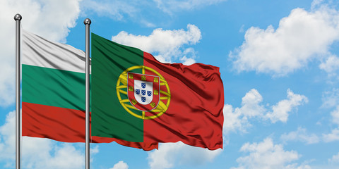 Bulgaria and Portugal flag waving in the wind against white cloudy blue sky together. Diplomacy concept, international relations.
