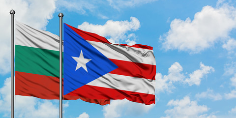 Bulgaria and Puerto Rico flag waving in the wind against white cloudy blue sky together. Diplomacy concept, international relations.