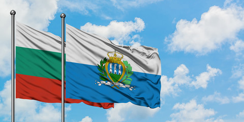 Bulgaria and San Marino flag waving in the wind against white cloudy blue sky together. Diplomacy concept, international relations.