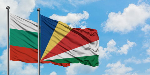 Bulgaria and Seychelles flag waving in the wind against white cloudy blue sky together. Diplomacy concept, international relations.