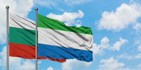 Bulgaria and Sierra Leone flag waving in the wind against white cloudy blue sky together. Diplomacy concept, international relations.
