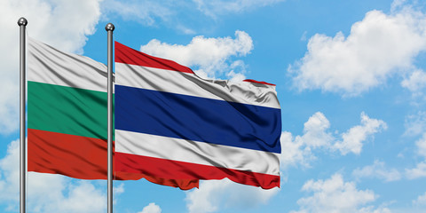 Bulgaria and Thailand flag waving in the wind against white cloudy blue sky together. Diplomacy concept, international relations.