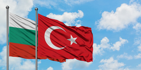 Bulgaria and Turkey flag waving in the wind against white cloudy blue sky together. Diplomacy concept, international relations.