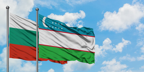 Bulgaria and Uzbekistan flag waving in the wind against white cloudy blue sky together. Diplomacy concept, international relations.