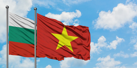 Bulgaria and Vietnam flag waving in the wind against white cloudy blue sky together. Diplomacy concept, international relations.