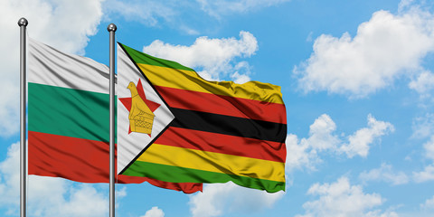 Bulgaria and Zimbabwe flag waving in the wind against white cloudy blue sky together. Diplomacy concept, international relations.